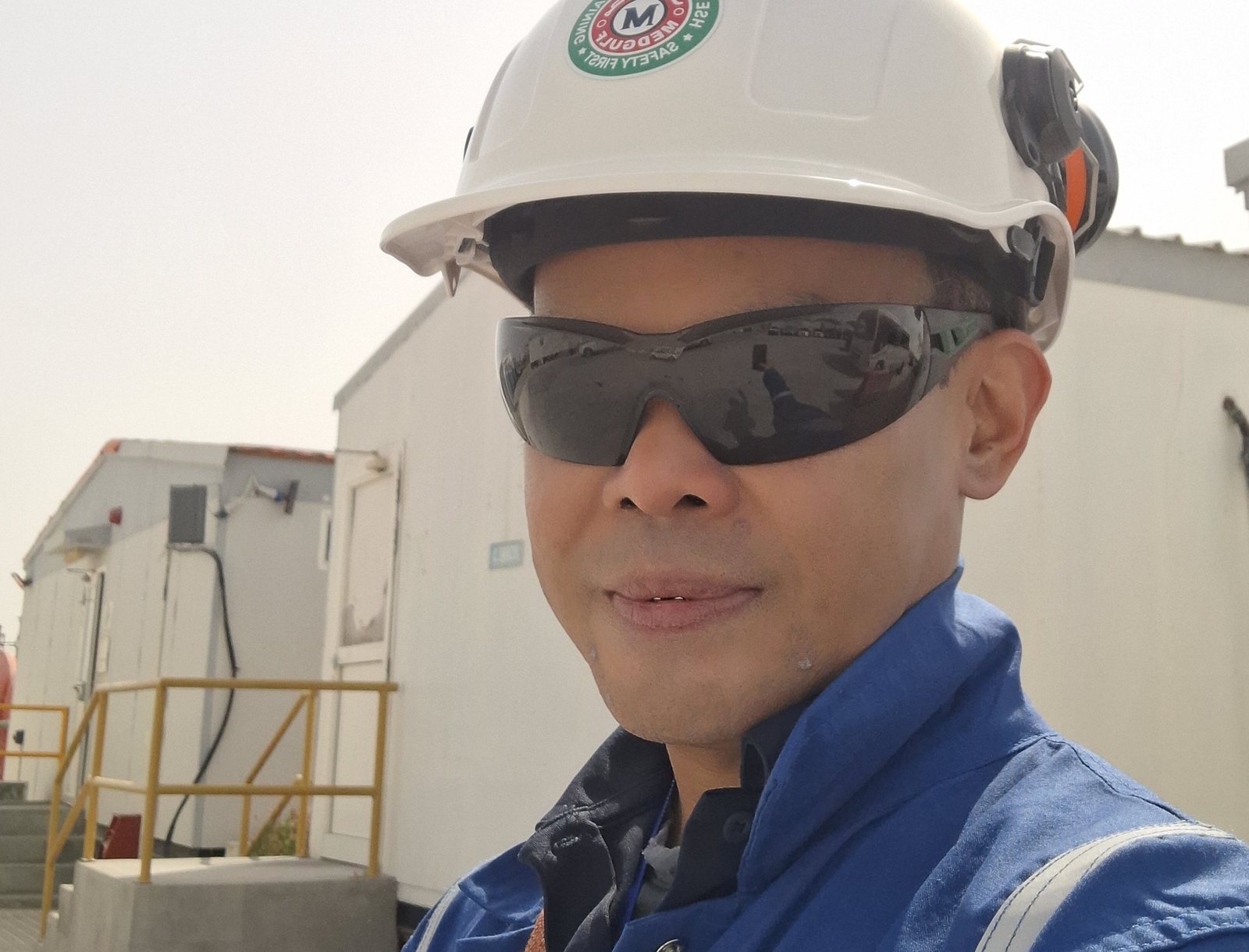 Allan Ronald Dones on site in hard hat, safety glasses and flame-resistant coveralls