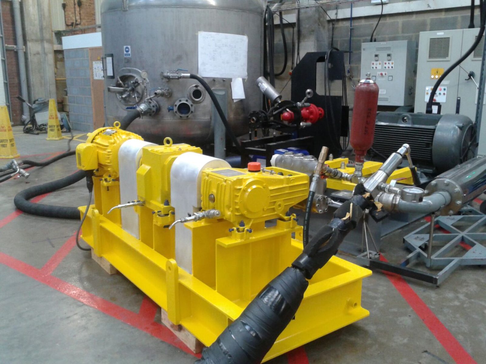 Packaged pump skid connected to a test rig with pulsation dampener and discharge piping